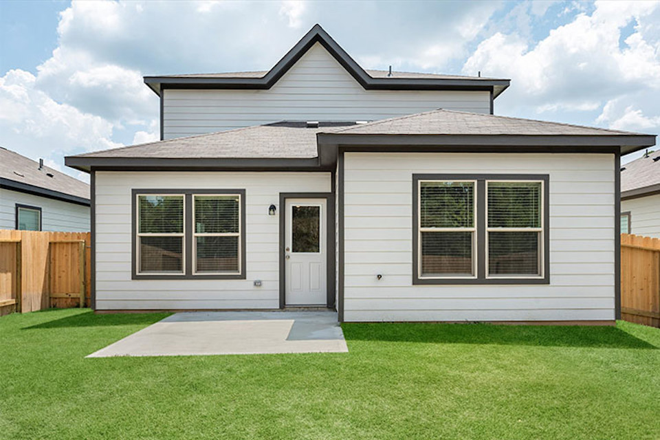 A house with a fence and grass.
