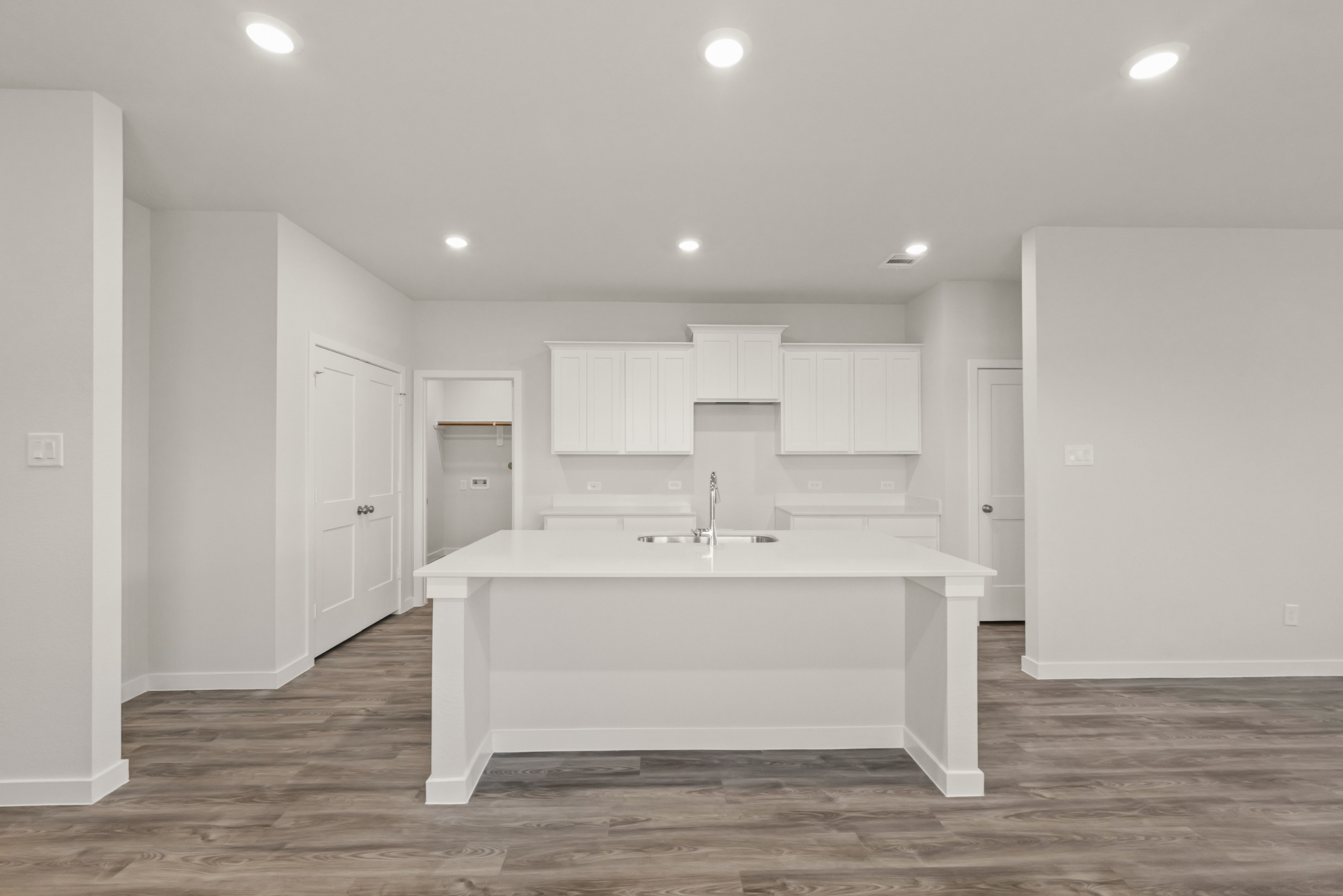 A white kitchen with a white counter.