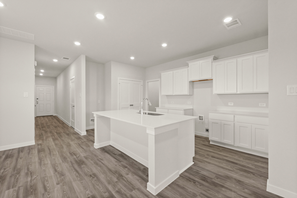 A kitchen with white cabinets.