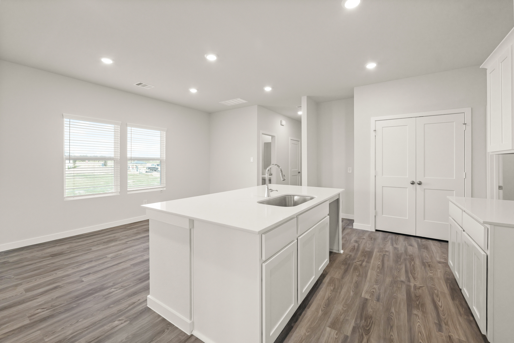 A large kitchen with white cabinets.