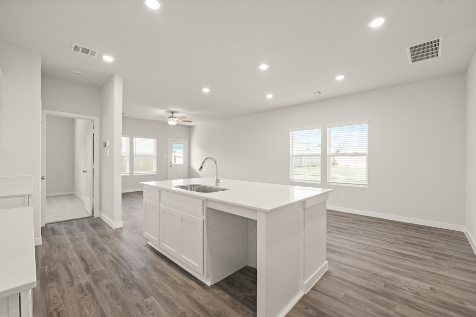 A kitchen with white cabinets.