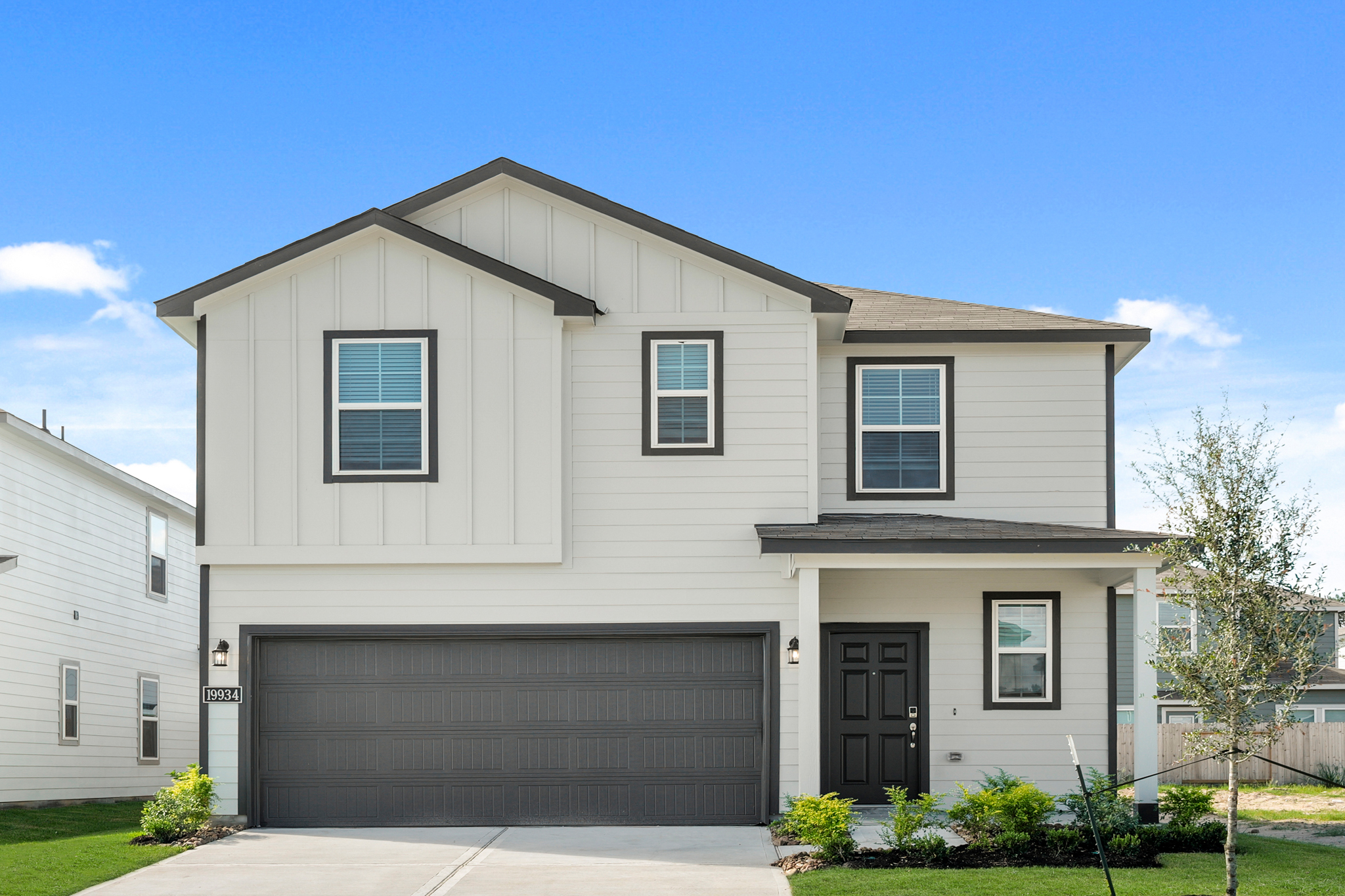 A grey house with a garage.