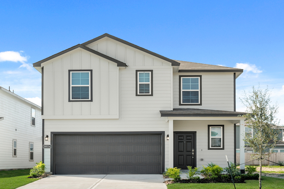 A grey house with a garage.