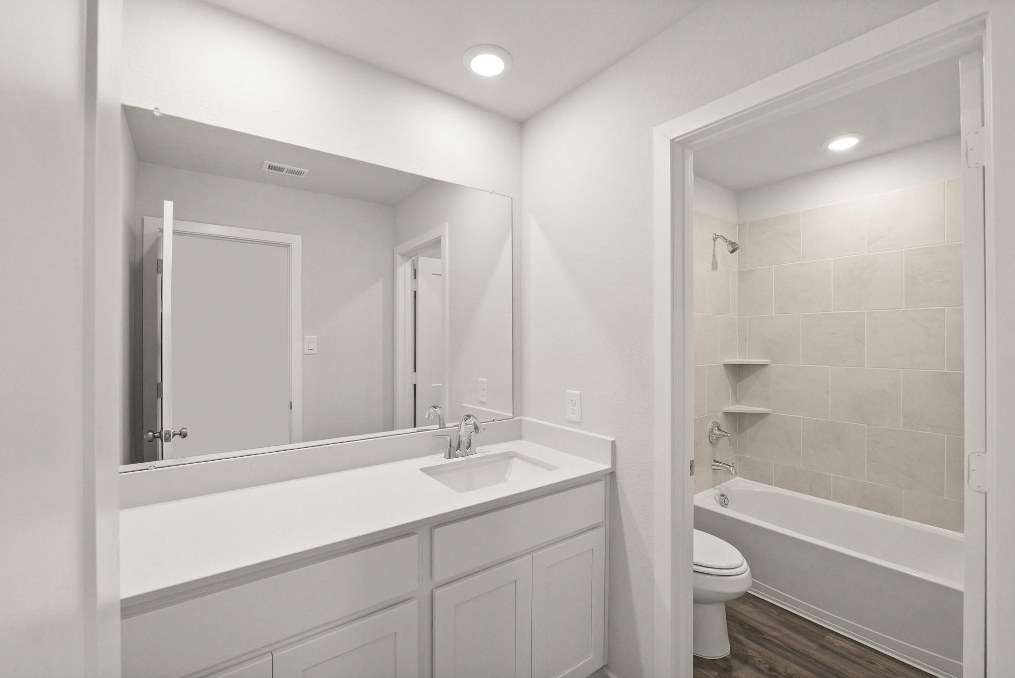 A bathroom with a tub sink and toilet.