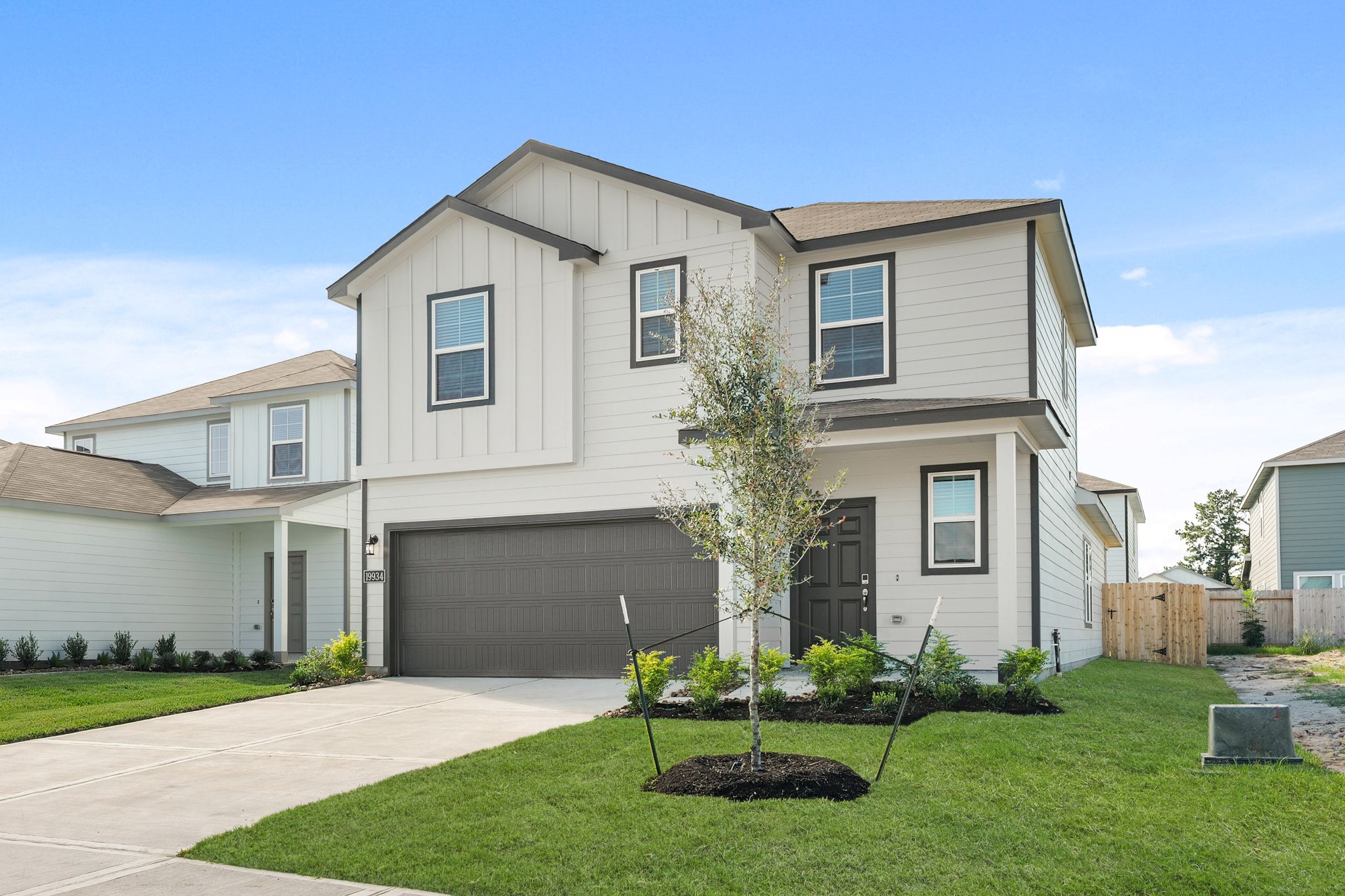 A house with a tree in the front yard.