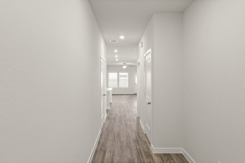 A long hallway with white walls.