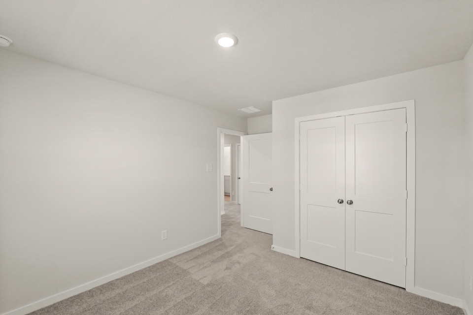A hallway with white doors.