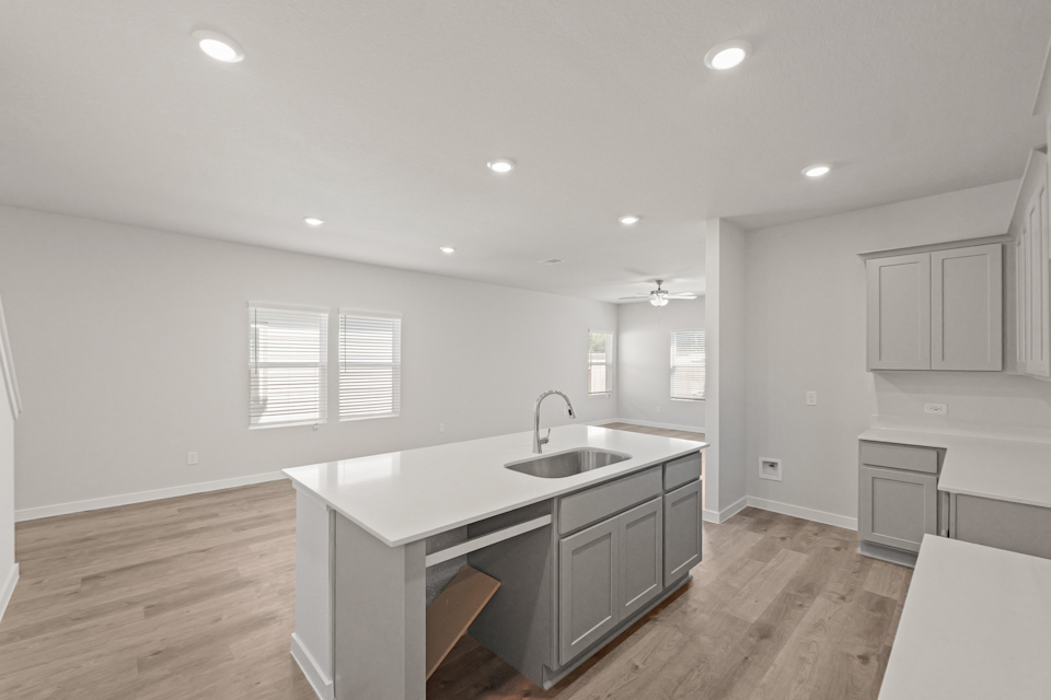 A kitchen with white cabinets.