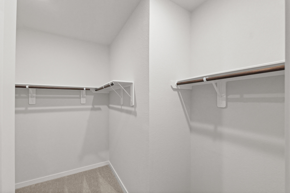 A white room with a metal bar.