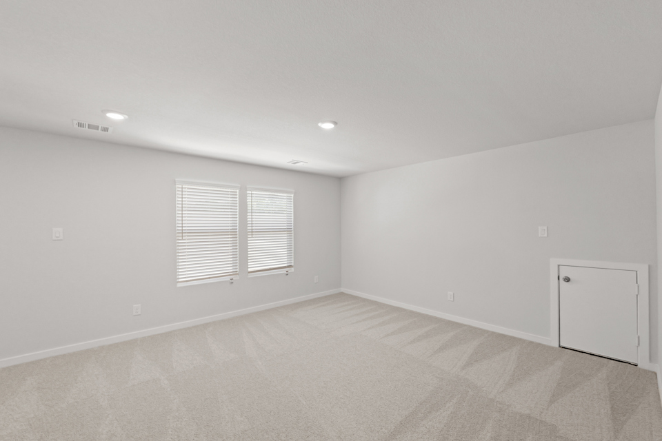 A room with a white wall and a window.