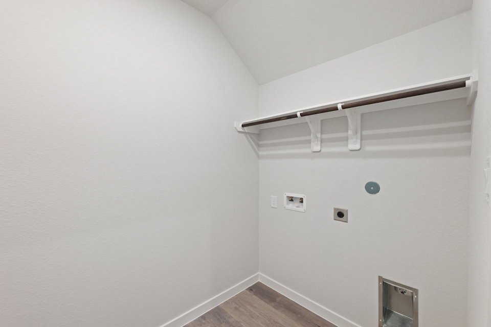 A white wall with a light fixture.