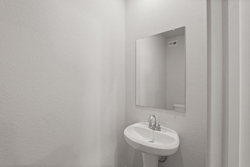 A bathroom with a mirror and sink.