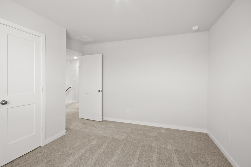 A hallway with white doors.