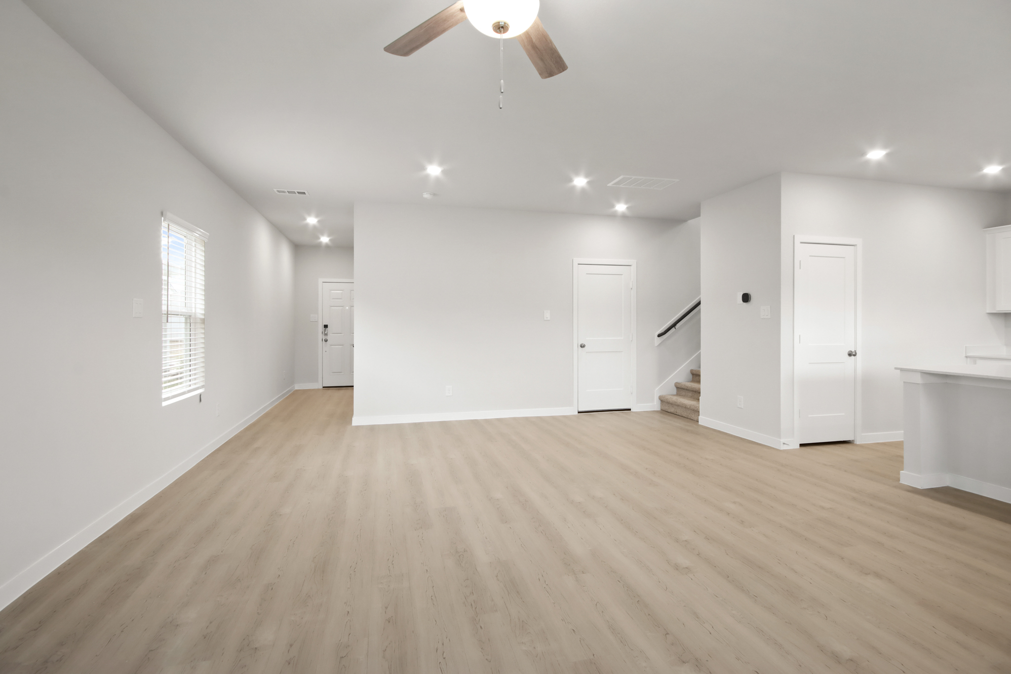 A room with white walls and a wood floor.
