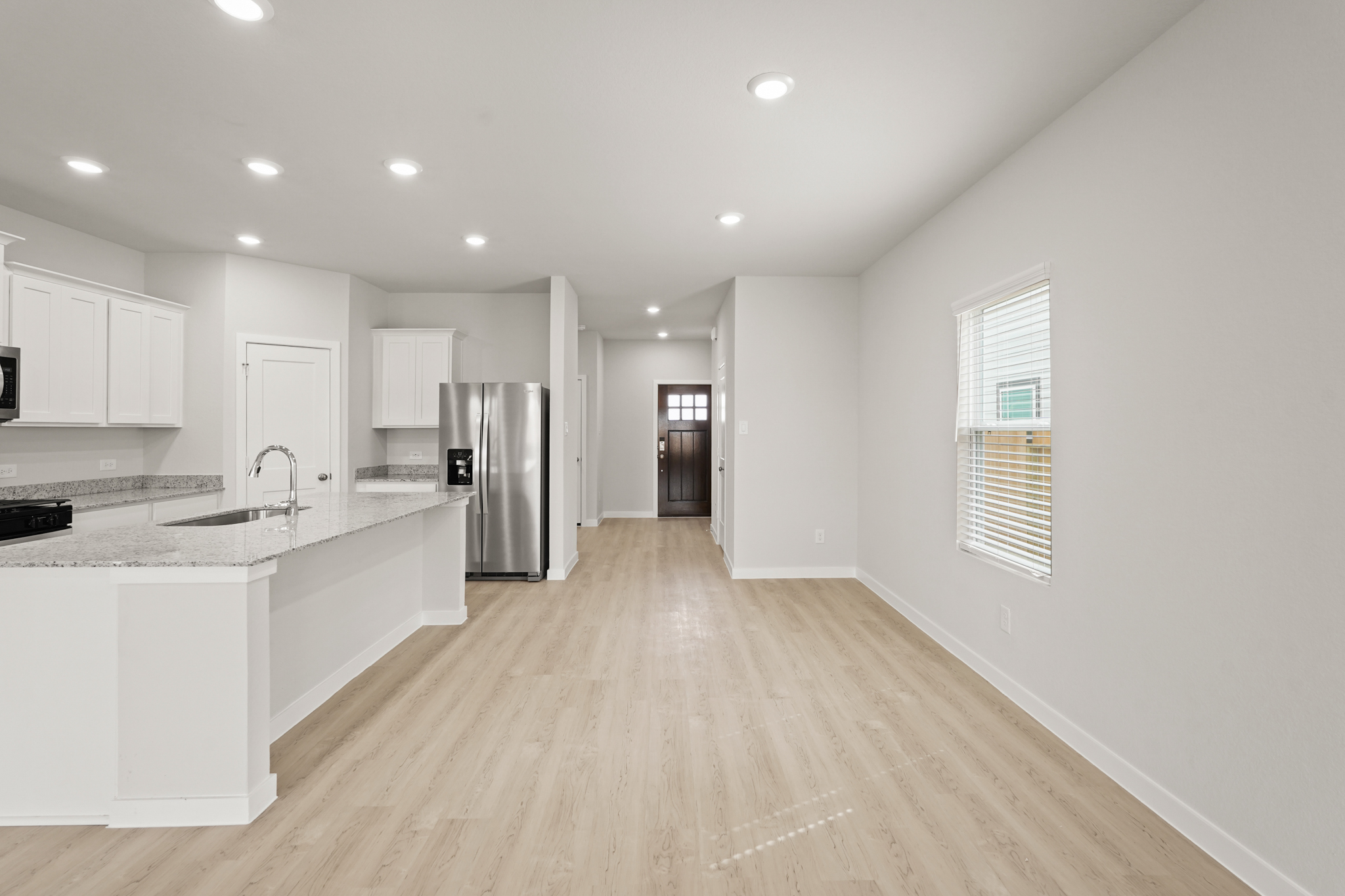 A kitchen with white cabinets.