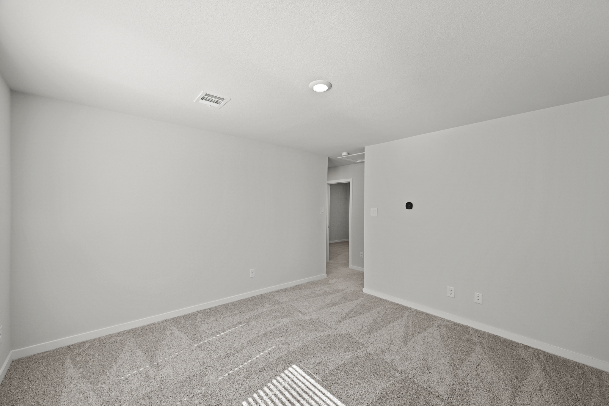 A hallway with white walls.