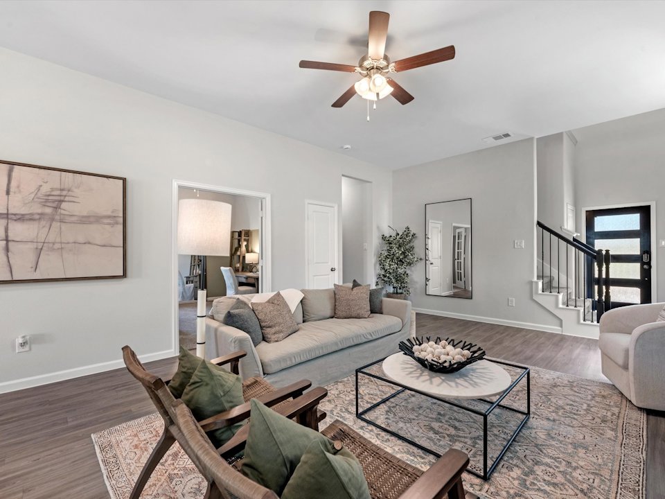A living room with a ceiling fan.