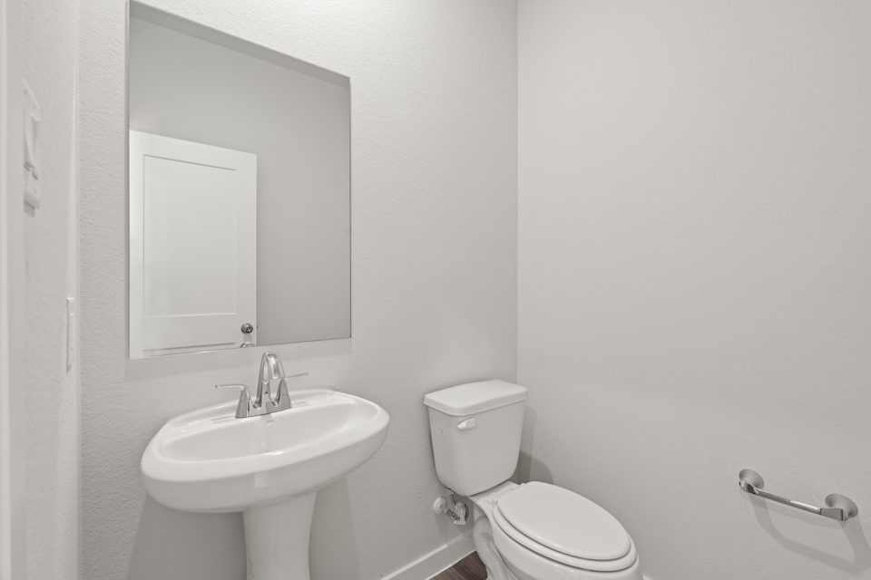 A bathroom with a toilet and sink.