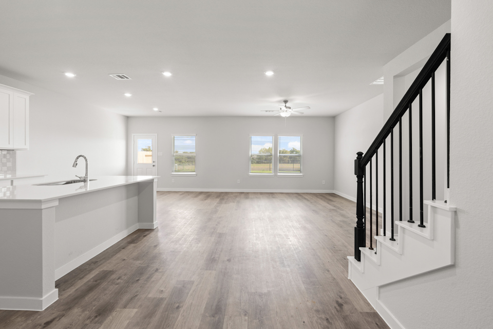 A large kitchen with a wood floor.