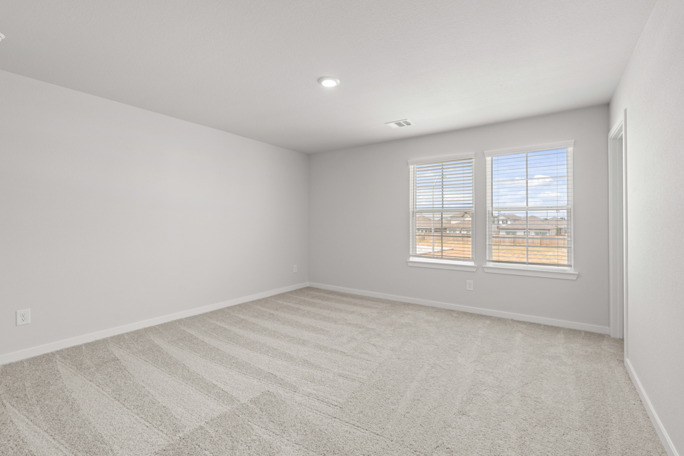 A room with a window and a carpet.