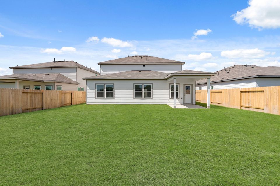 A green lawn in front of a house.