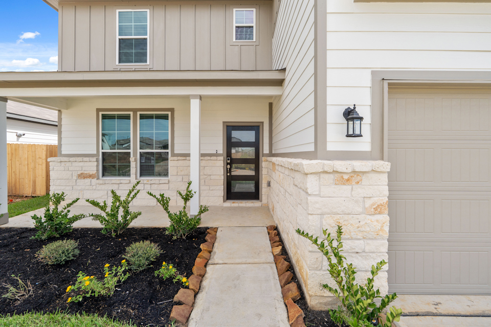A house with a front door and a driveway.
