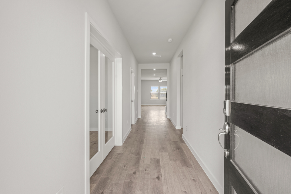 A hallway with white walls.