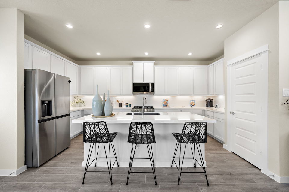 A kitchen with white cabinets.