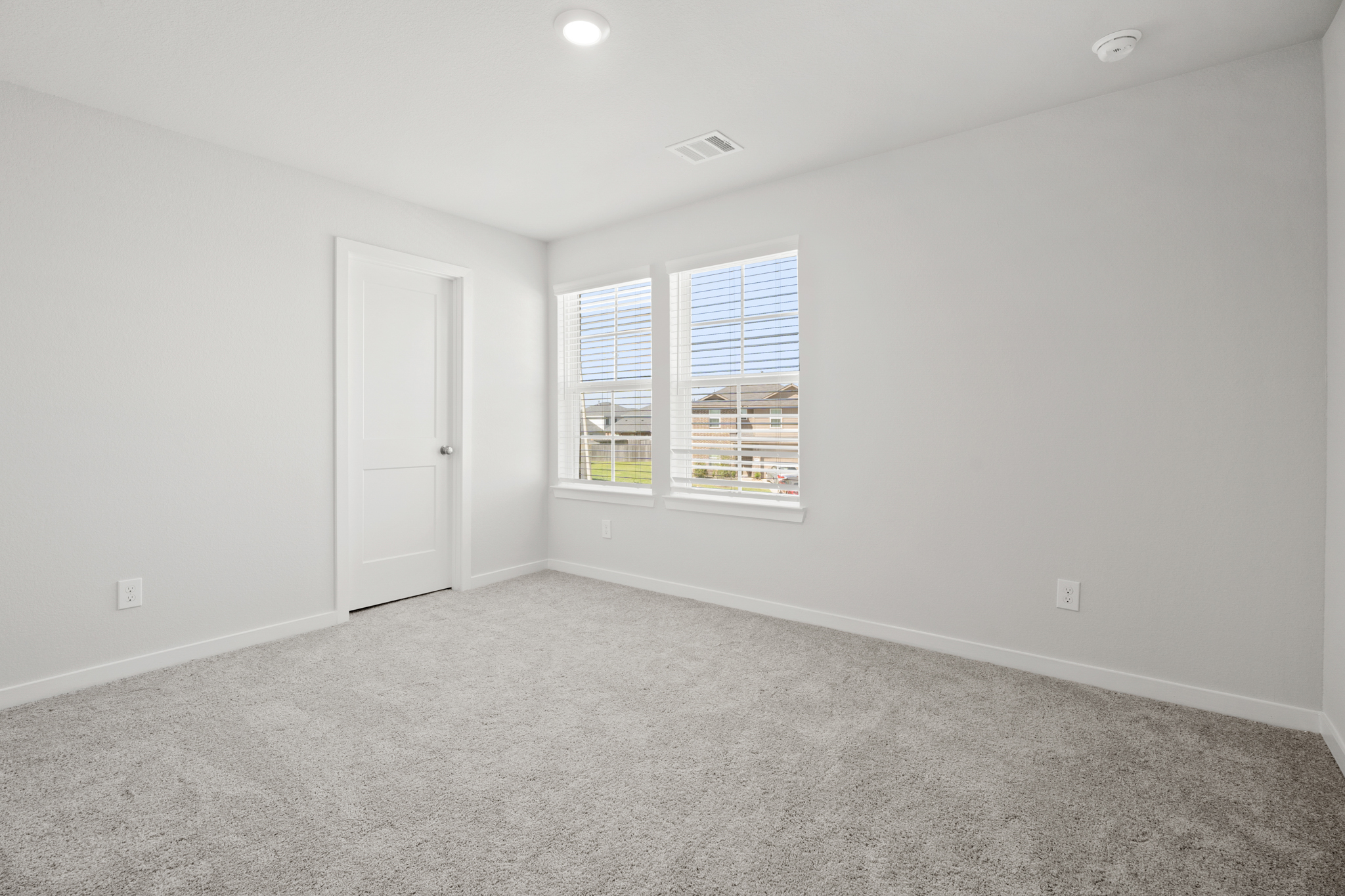 A room with a white door and a window.