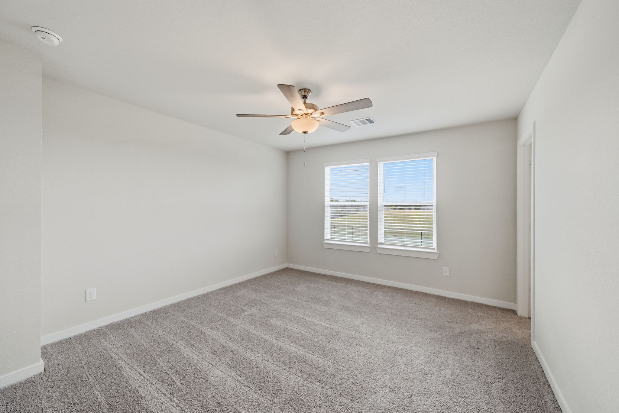 A room with a ceiling fan and a ceiling fan.