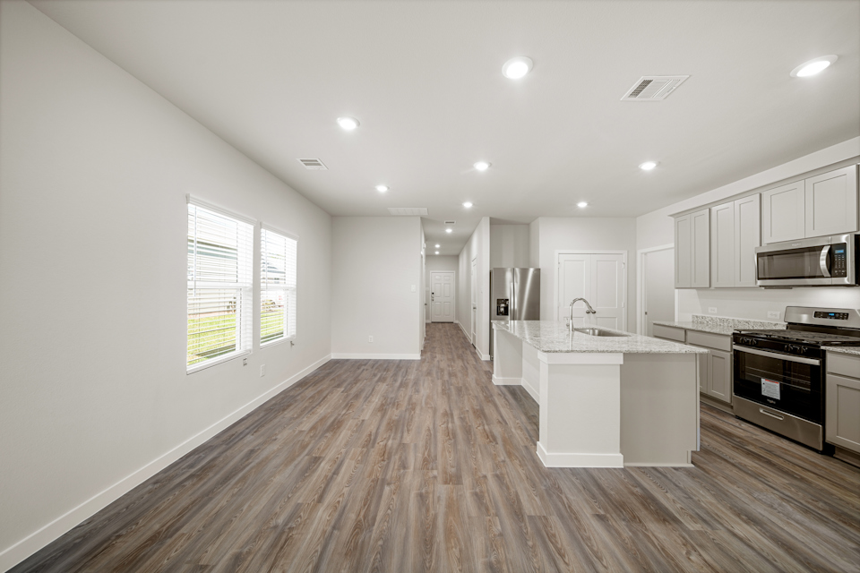 A kitchen with white cabinets.