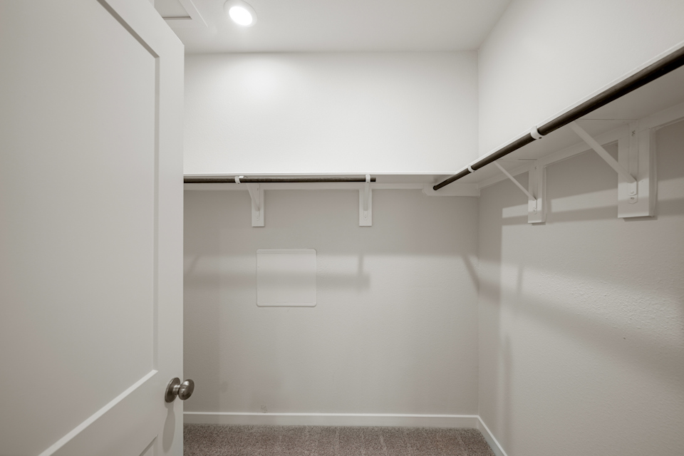 A white room with a staircase.