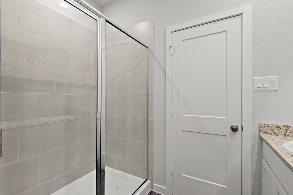 A bathroom with a glass shower.