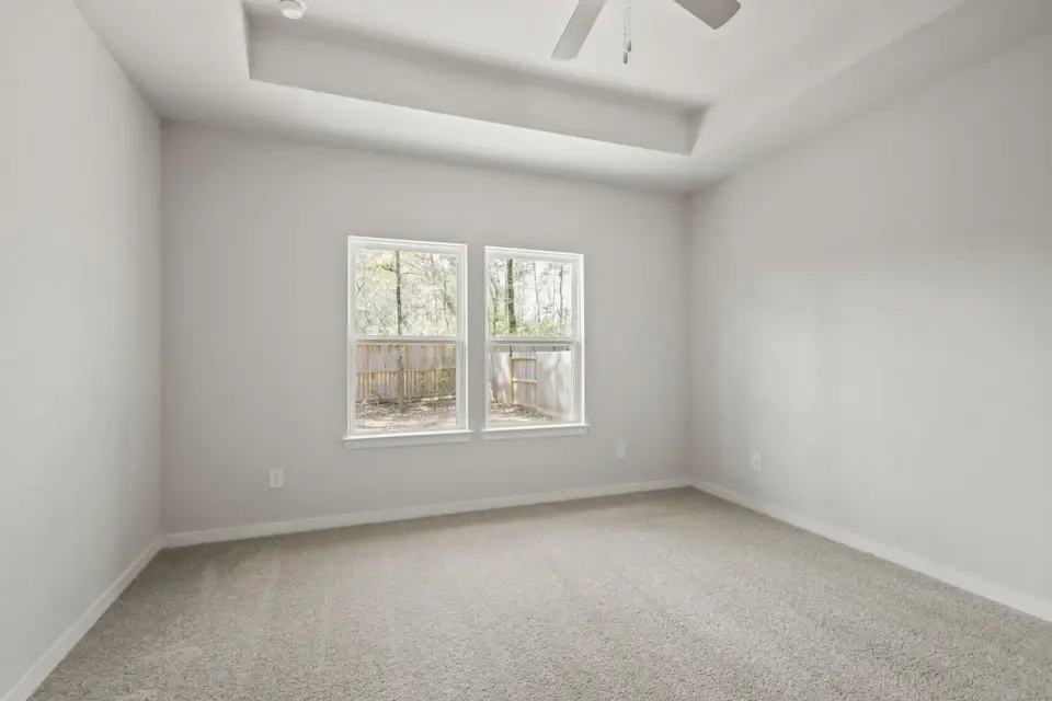 A room with a window and a carpet.