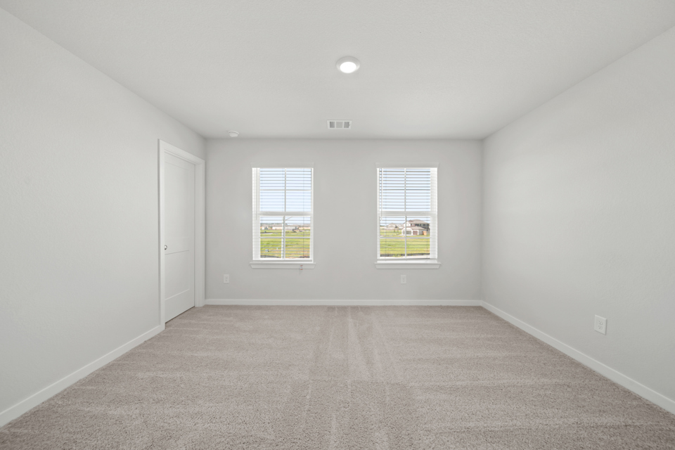 A room with white walls and a window.