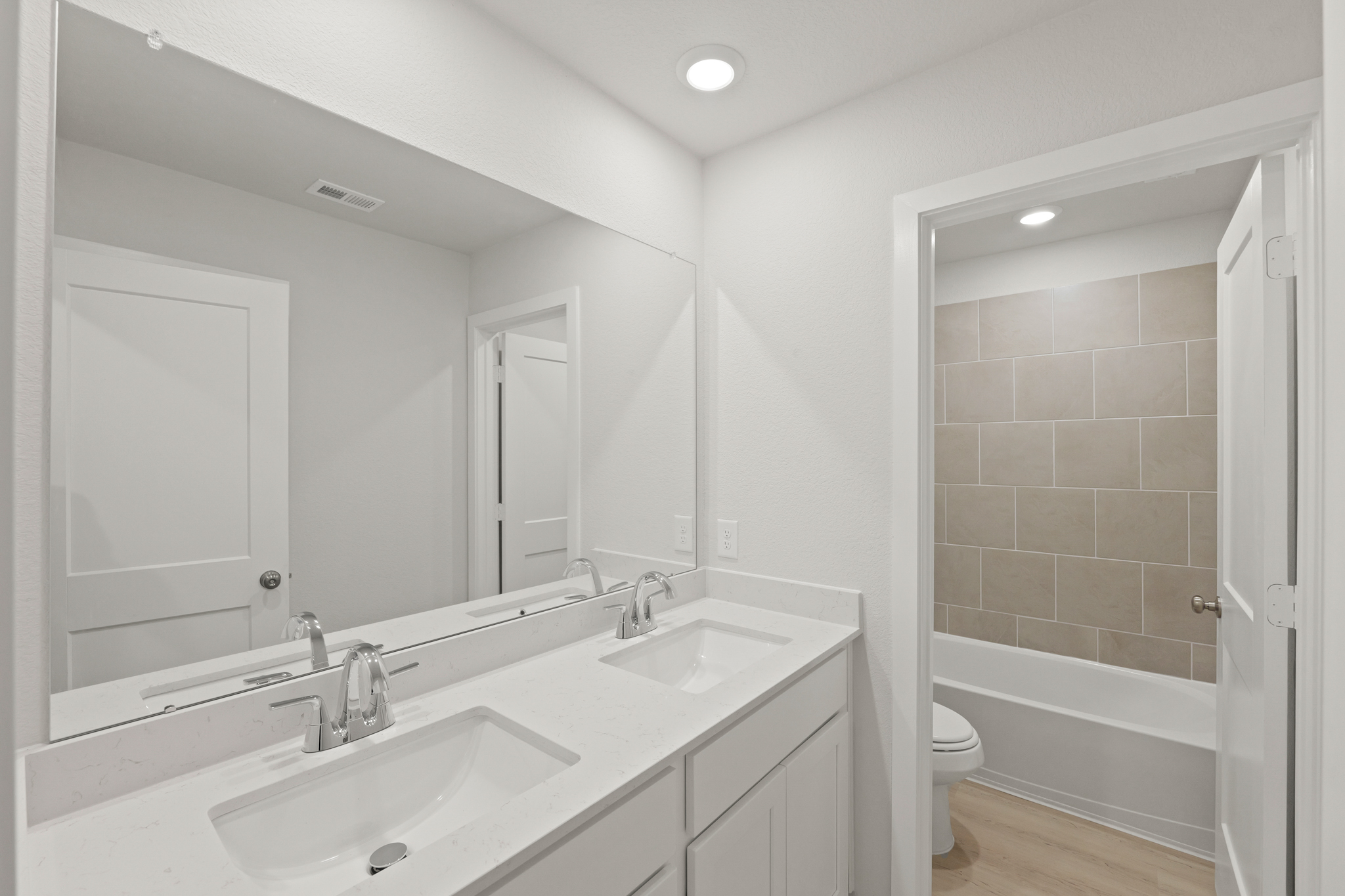 A bathroom with a tub sink and toilet.