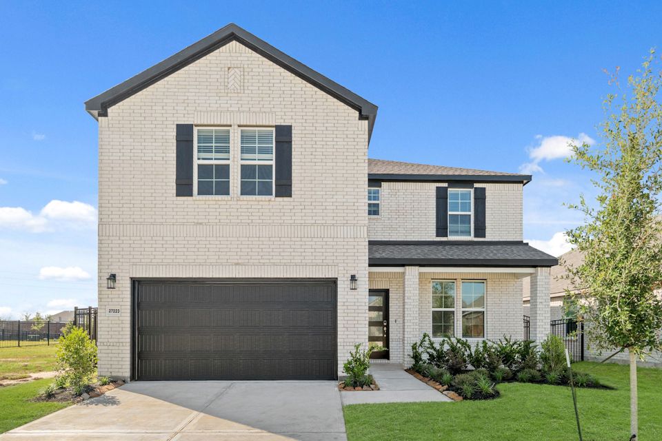 A grey house with a garage.