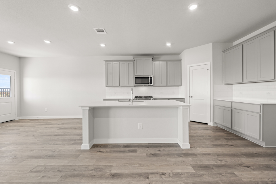 A kitchen with white cabinets.
