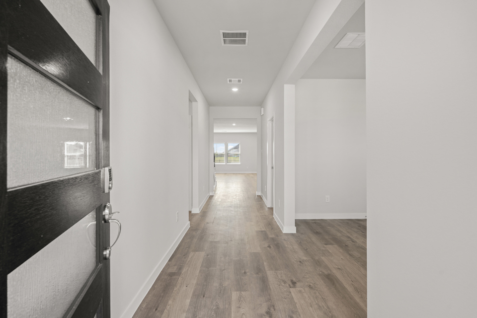 A hallway with white walls.