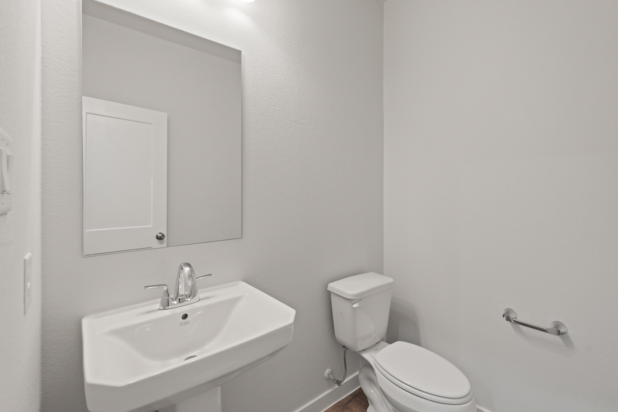 A bathroom with a toilet and sink.