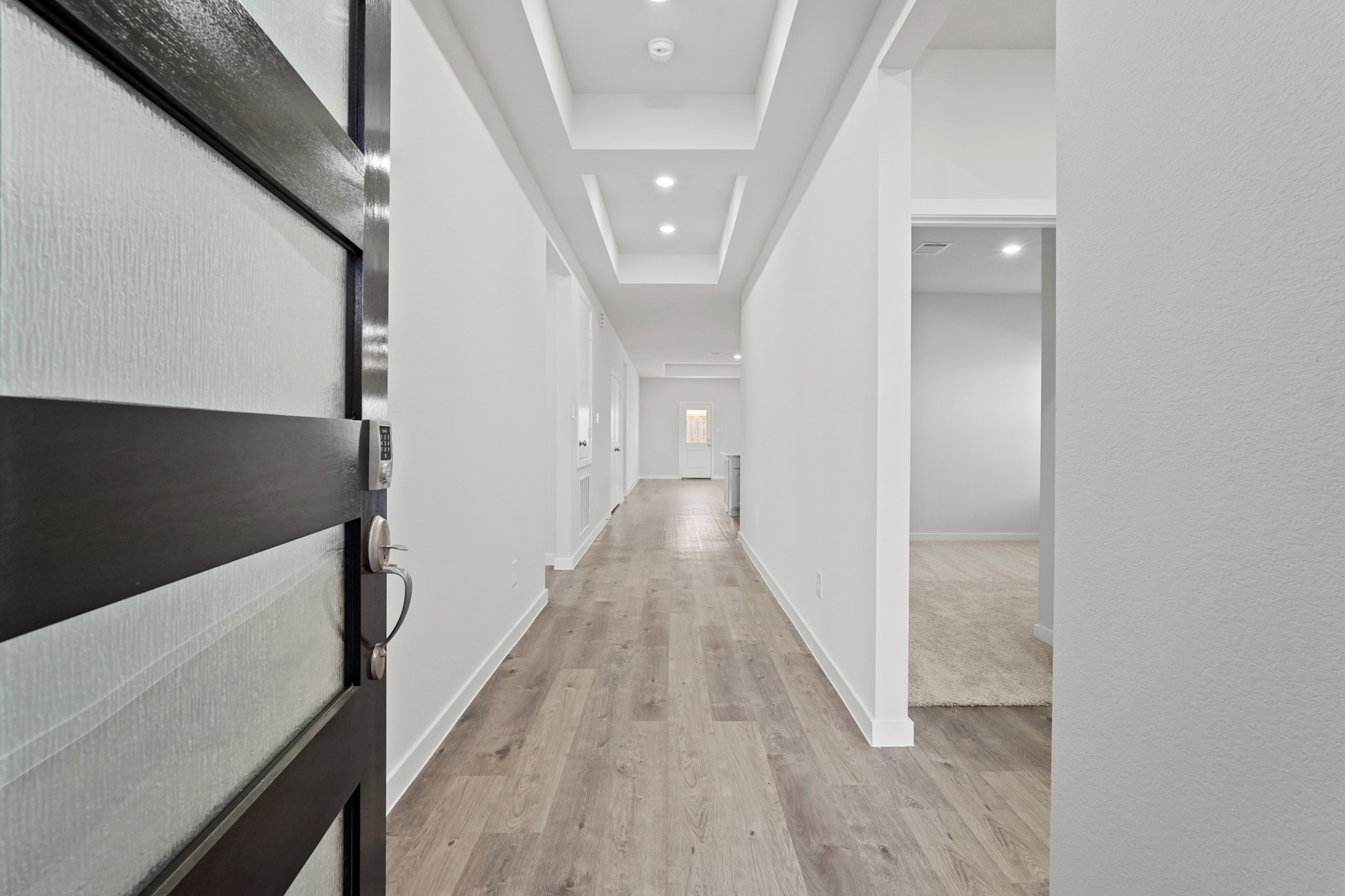 A hallway with white walls.