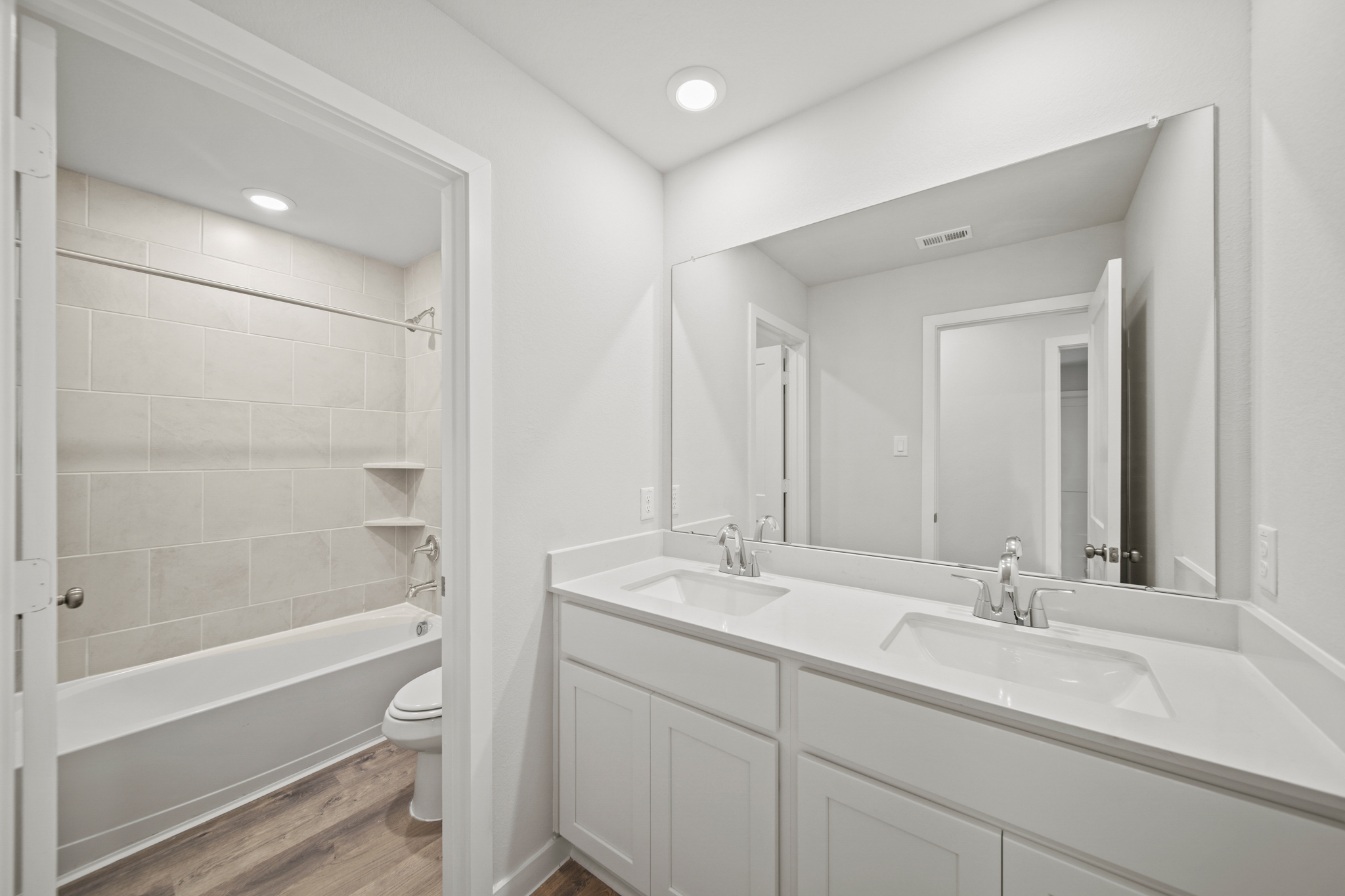 A bathroom with a tub sink and toilet.