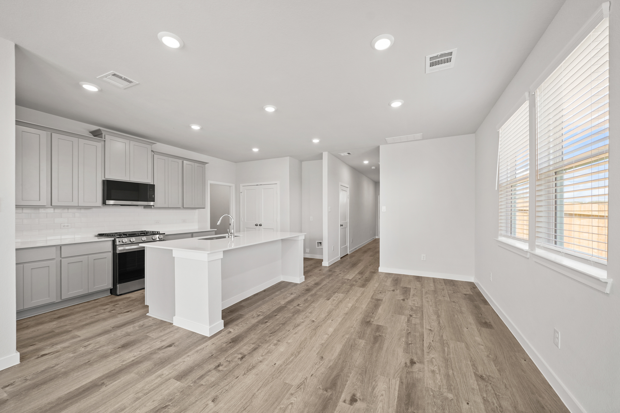 A kitchen with white cabinets.