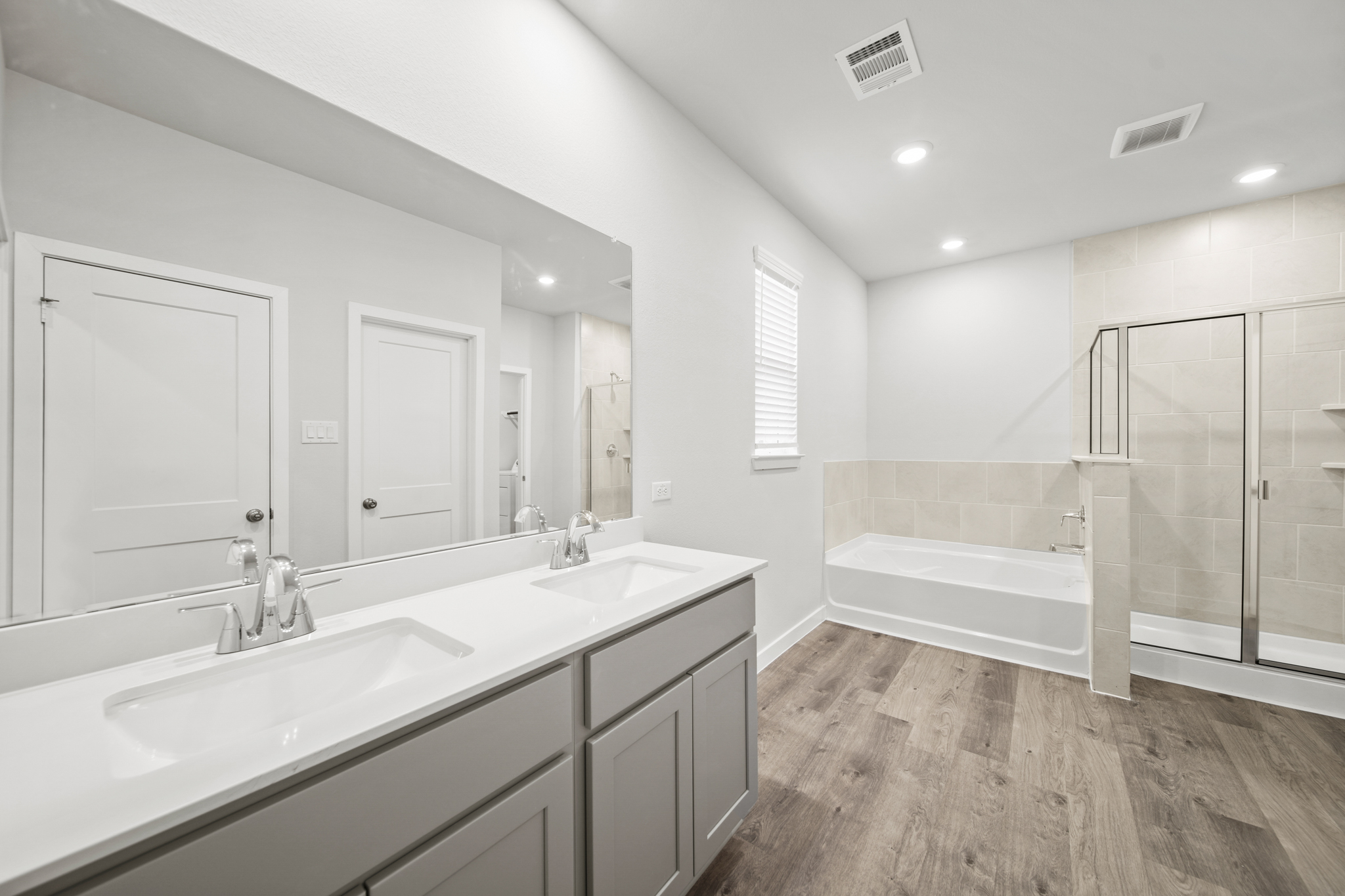 A bathroom with a tub sink and a shower.