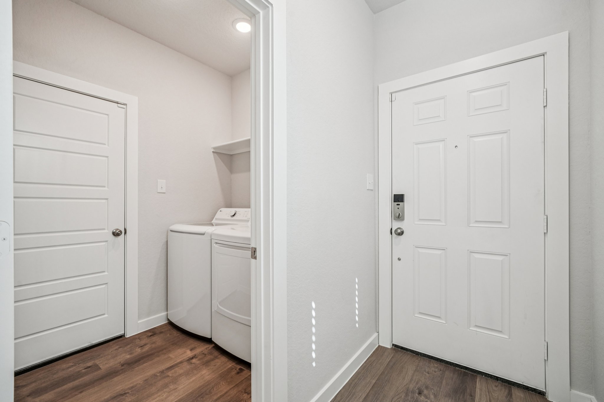 A white room with a white door.