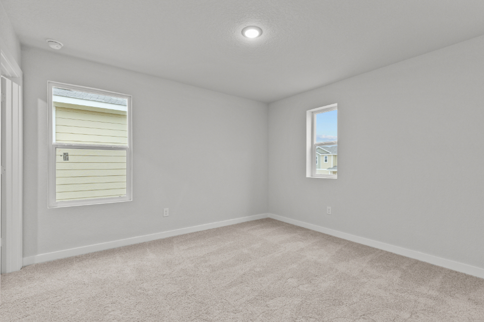 A room with a window and a carpet.