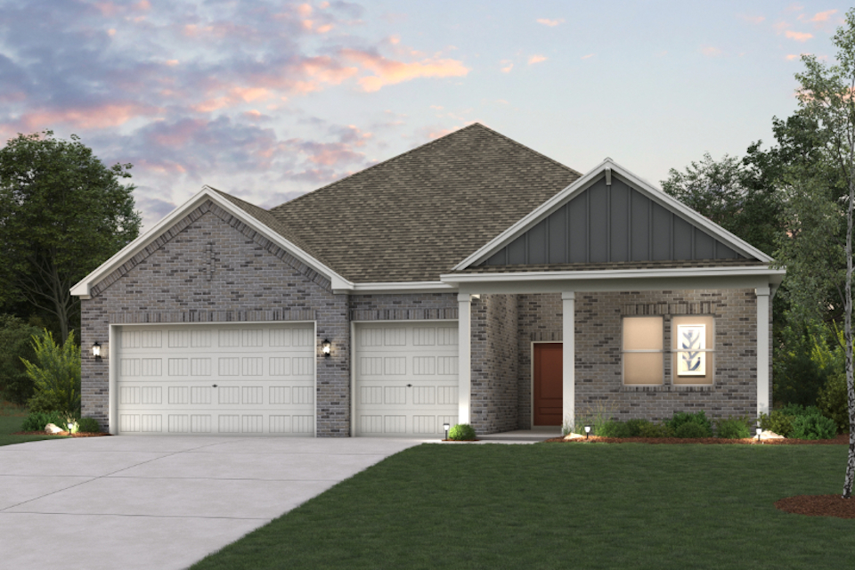 A house with garages and a lawn.
