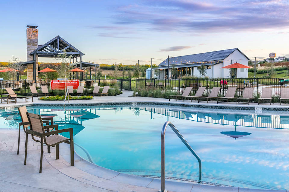 A pool with chairs around it.