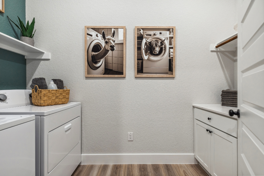 A white kitchen with a white cabinet and a basket with a picture on it.