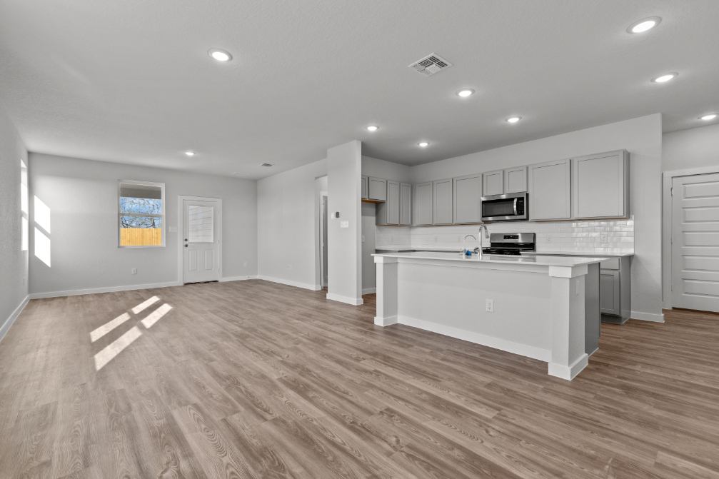 A large kitchen with white cabinets.